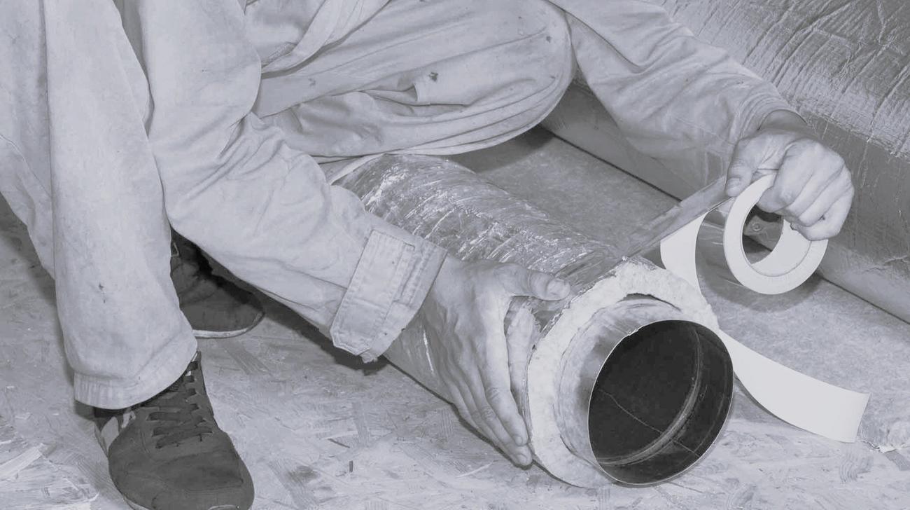 Technician tapes flexible air duct